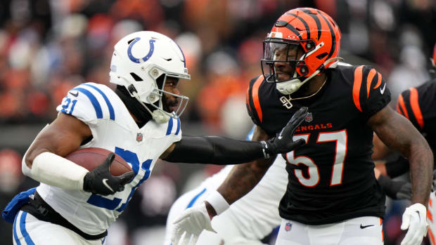 Dec. 10, 2023; Cincinnat, Ohio, USA; Indianapolis Colts running back Zack Moss (21) carries the ball as Cincinnati Bengals linebacker Germaine Pratt (57) defends in the first quarterat Paycor Stadium.